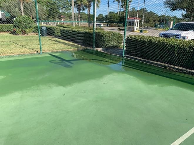 Images pressure washing tennis court in the greater Tampa Bay area Florida.