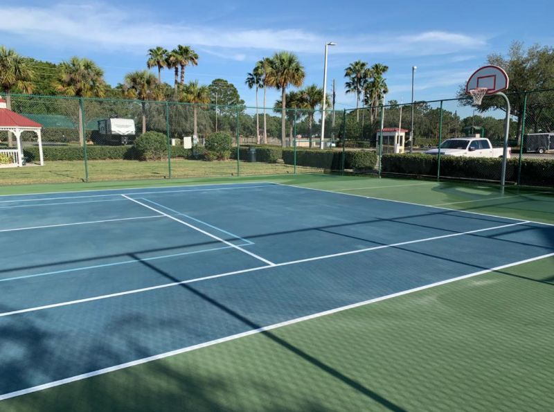 Cleaning a tennis court for a customer in Tampa Bay.